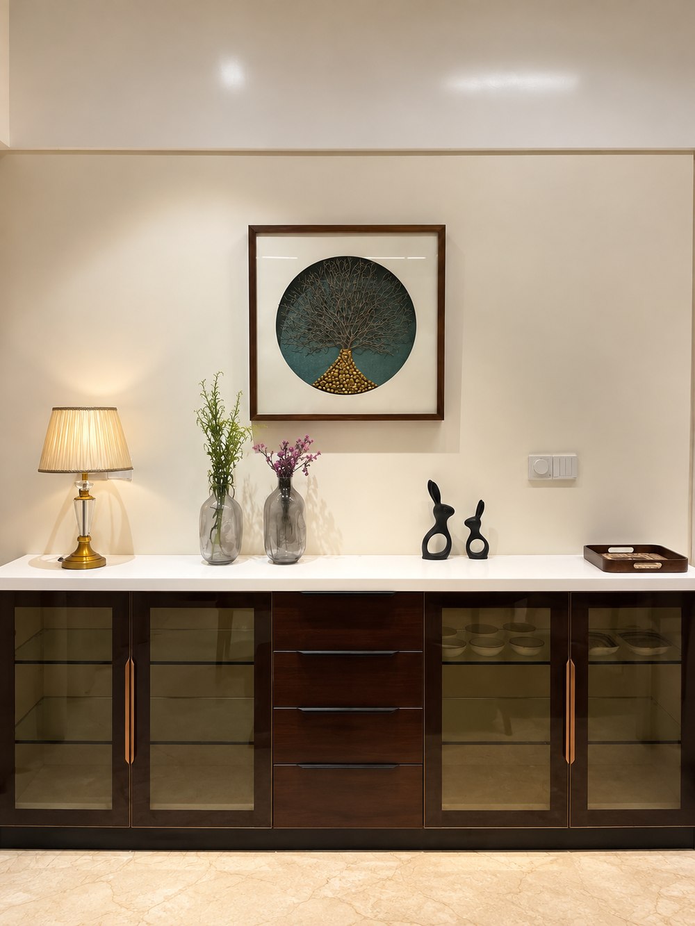 Joshi House - the entrance console, in dark wood with glass-fronted display cabinets