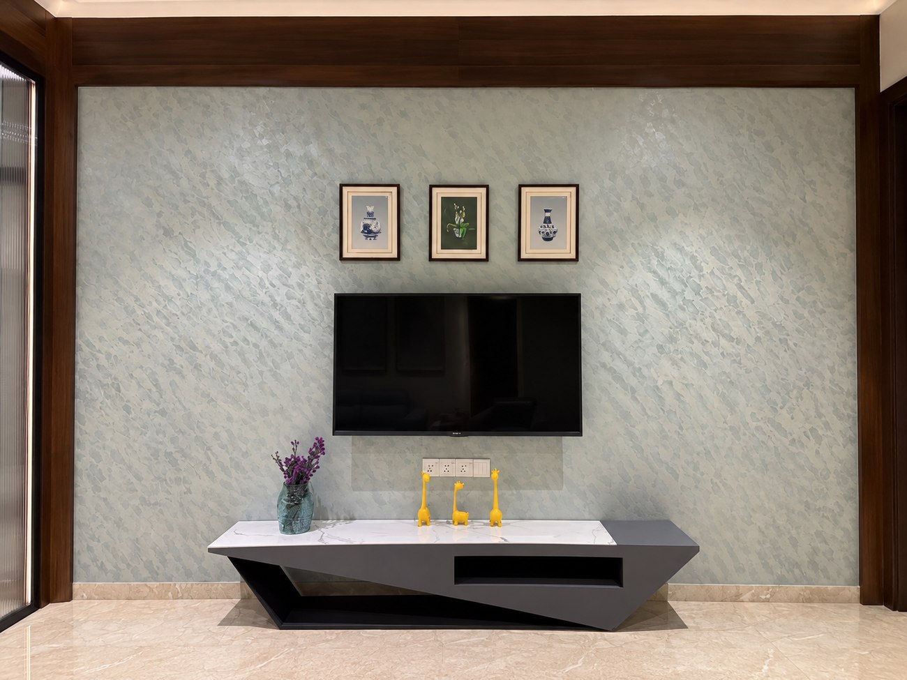 Joshi House - the TV console, in angular charcoal grey and white marble