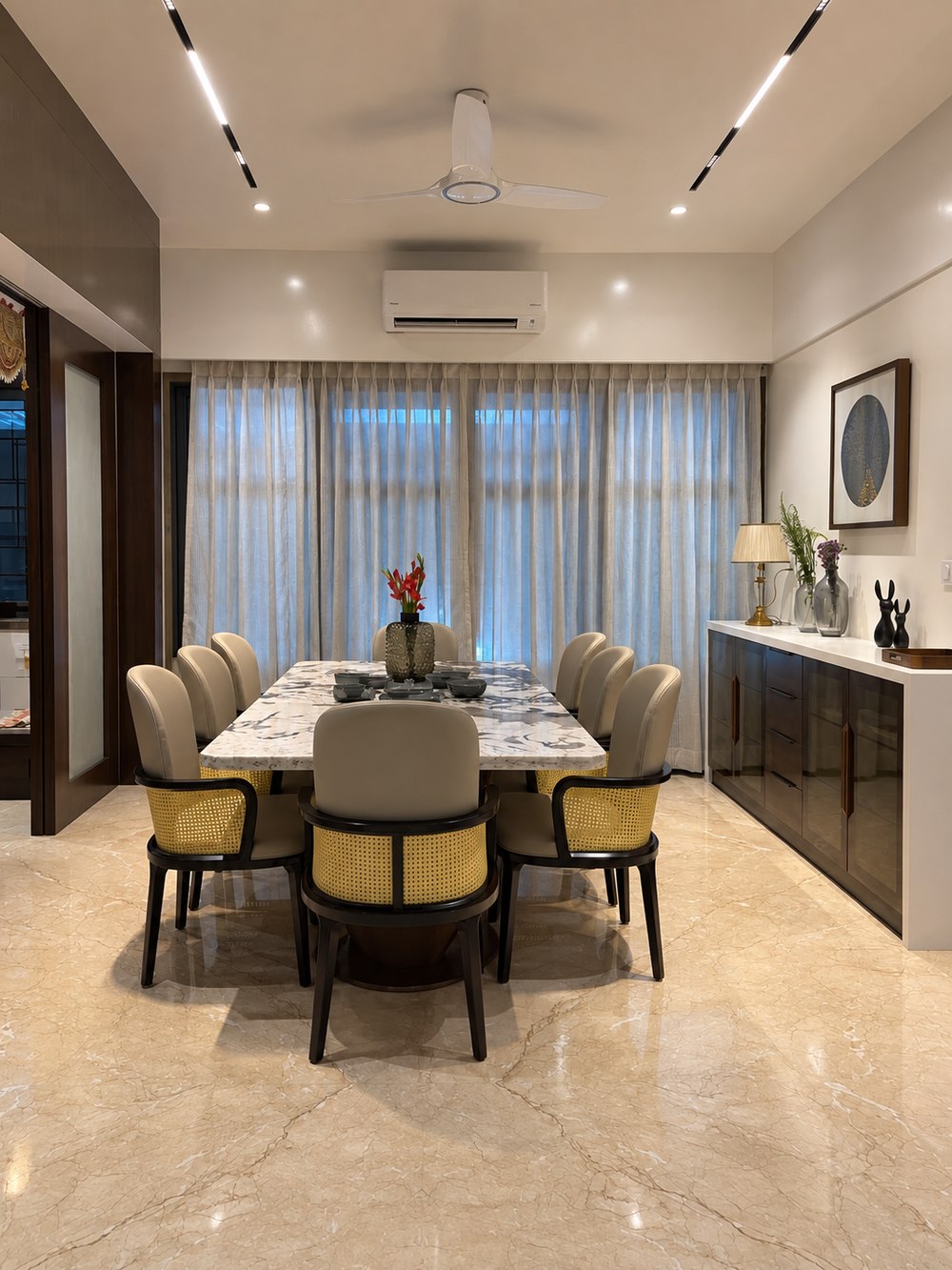 Joshi House - the dining table, seating eight beneath soft curtained light