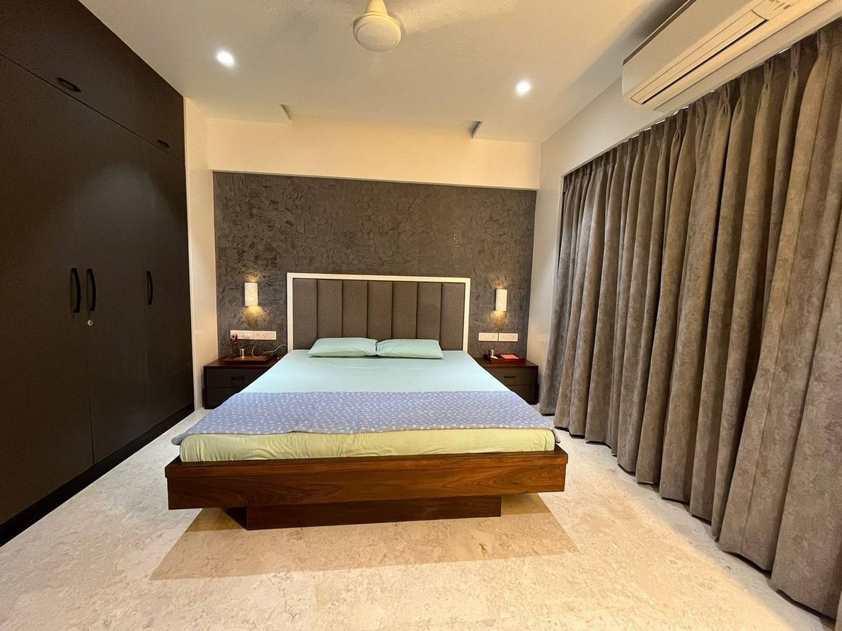 The Kogta House - master bedroom with floating wood bed and tufted headboard