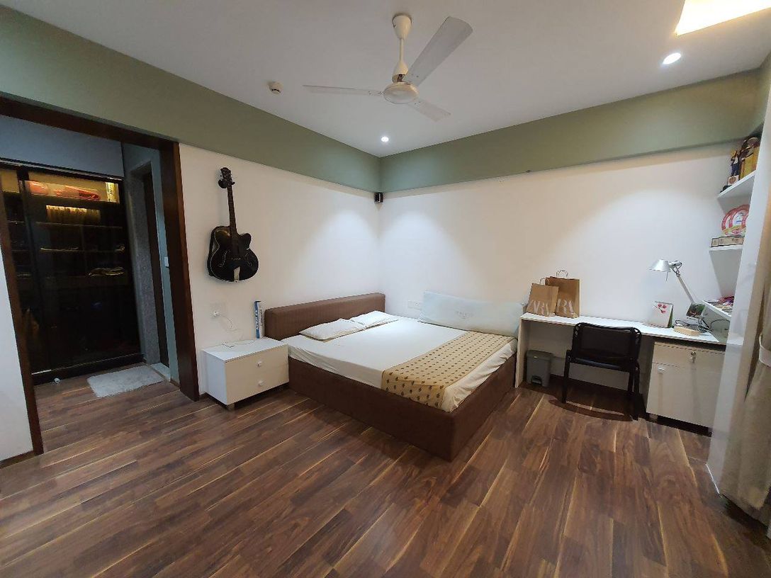 The Kogta House - bedroom with wall-mounted guitar and study desk